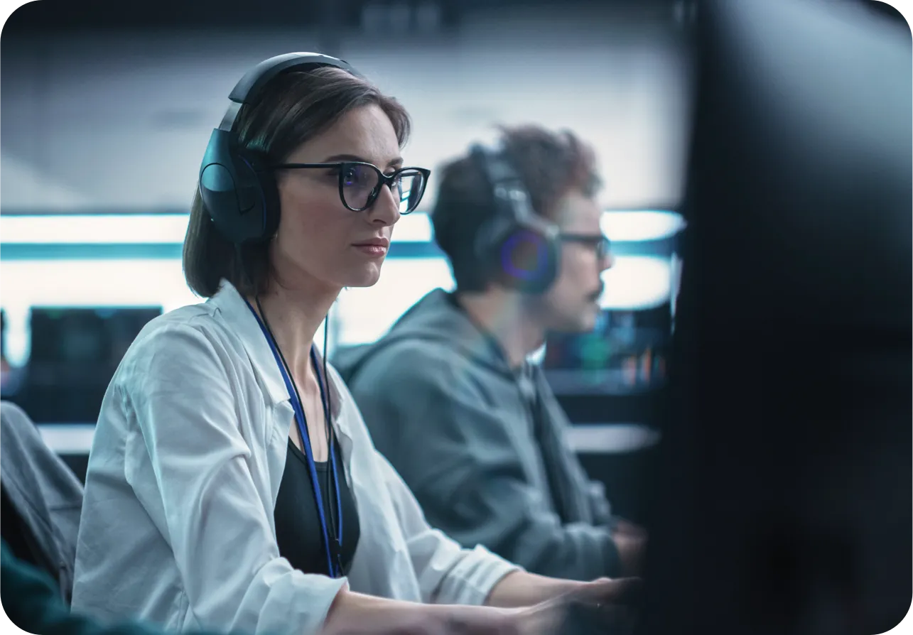 young female customer service worker in glasses and headphones looking at computer stock image rounded corners