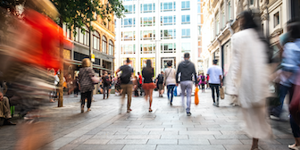Stock image blurred walking shoppers on high street